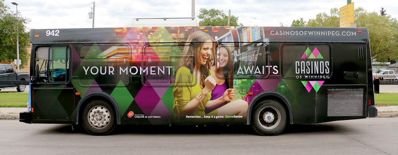 City transit bus carrying a full-body printed vinyl wrap.